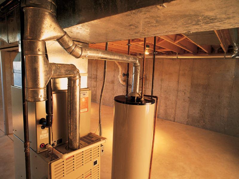 A clean and well-maintained furnace in a home. Annual Furnace Servicing for Warranty Protection.