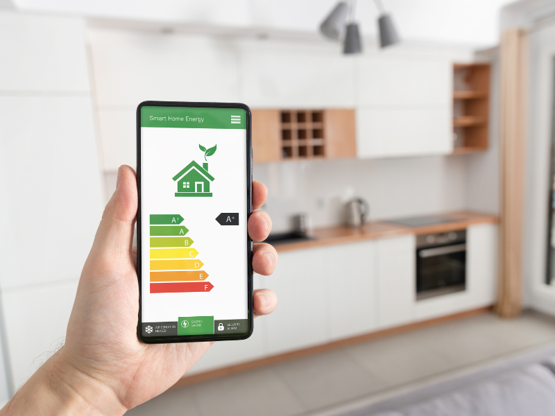 A smartphone displaying energy savings on a smart thermostat app. What Homeowners Need to Know About Smart Thermostats.