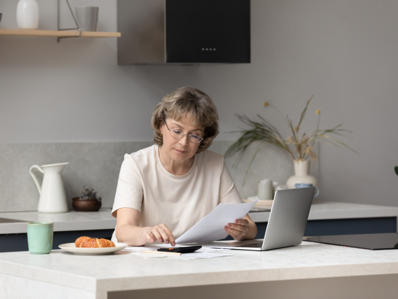 An Edmonton homeowner looking at their heating bill. When To Replace Your Furnace.