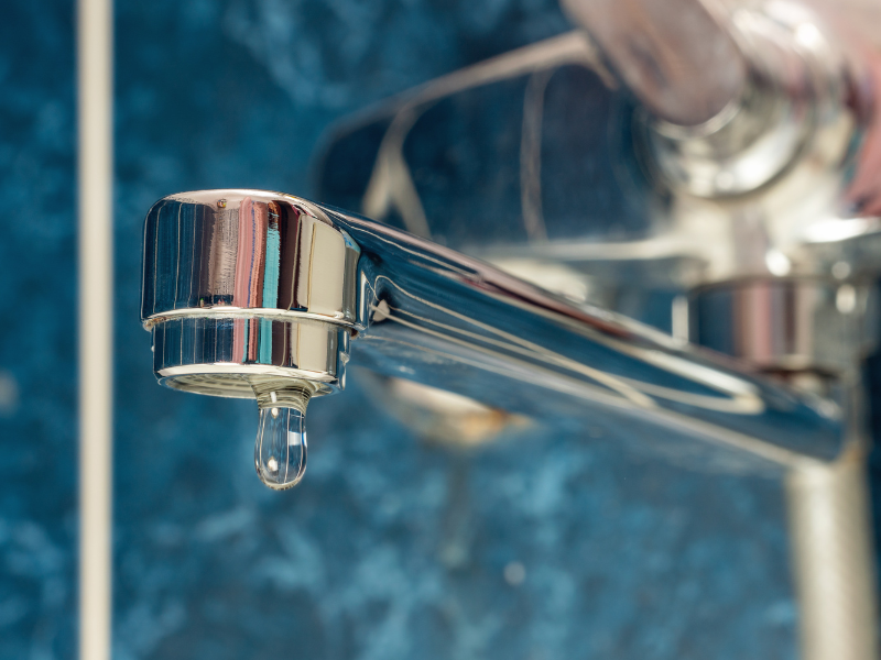 A faucet in an Edmonton home dripping water, indicating a leak. Preventing Clogged Drains and Leaks, expert tips from the plumbers at Habberjam At Home.