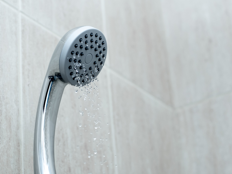 A detachable showerhead spewing water at a colder temperature than expected.