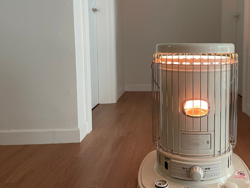 Using a space heater within the home to gradually thaw a frozen pipe.