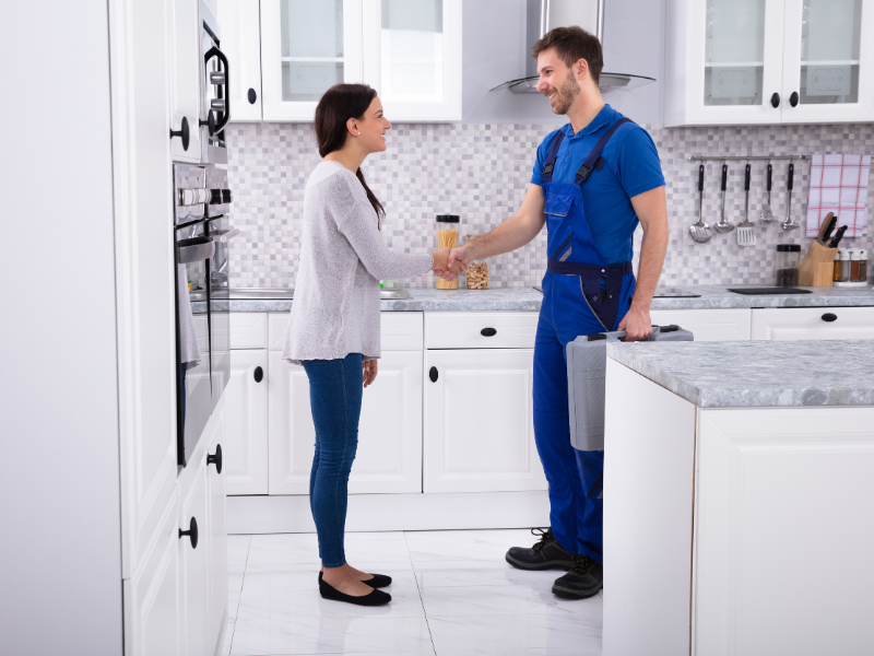 Trusted Edmonton plumber shaking hands with a satisfied customer.