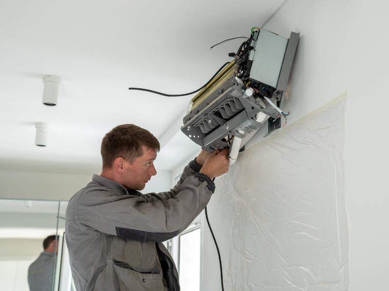 HVAC technician cleaning ducts in Edmonton home. 