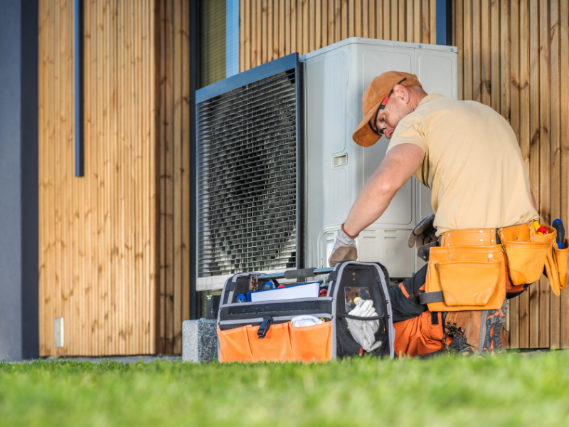 Professional performing a spring HVAC maintenance check in an Edmonton home.